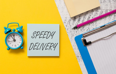 Word writing text Speedy Delivery. Business photo showcasing provide products in fast way or same day shipping overseas Notepads clipboard colored paper sheet marker alarm clock wooden background