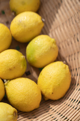 Composition of lemons setting in basket in natural light scene / food material / food background / raw material / food photography