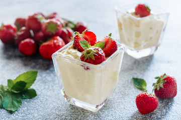 Strawberry Panakota Italian Cool Sweet Dessert . Classic Tasty Meal Dairy Cooked Cream Cheese with Ripe Berries Thickened with Gelatin and Molded Decorated Green Leaves. Panna Cotta Closeup Photo