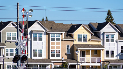 Exterior view of residential buildings built next to railroad tracks in Silicon Valley, Mountain View, South San Francisco bay area, California