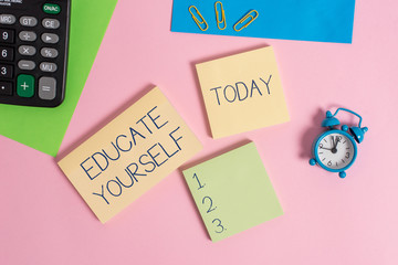 Conceptual hand writing showing Educate Yourself. Concept meaning prepare oneself or someone in a particular area or subject Alarm clock calculator notepads paper sheet color background