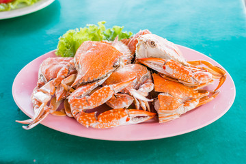 Steamed crabs on a plate on the table.