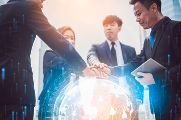 Close up of businessmen shaking hands. Global network and a world map in the foreground. block...