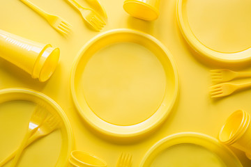 Singe use picnic utensils for recycling on yellow. Environment eco friendly discarded plastic...