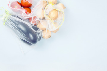 Zero waste. Vegetables in grocery bags on a gray background, copy space