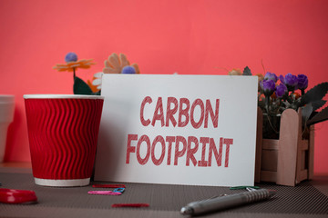 Writing note showing Carbon Footprint. Business concept for amount of dioxide released atmosphere...