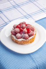 Brownie with cream and raspberry berries