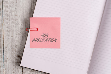 Writing note showing Job Application. Business concept for The standard business document serves a number of purposes Notebook stationary placed above classic wooden backdrop