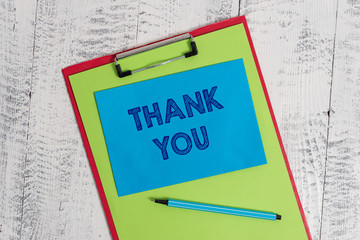 Text sign showing Thank You. Business photo showcasing a polite expression used when acknowledging a gift or service Colored clipboard blank paper sheet marker sticky note wooden background