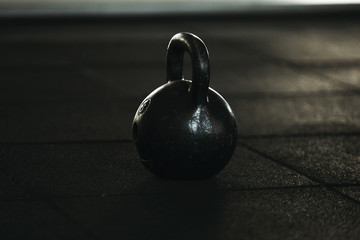 Naklejka na ściany i meble Gym equipment. The steel weight standind on the black rubber floor. Workout.