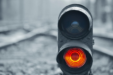 Traffic light shows red signal on railway. Red light