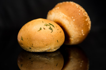 Tea bun on a black background. Photographed close up.