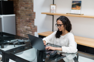 Businesswoman entrepreneur working on laptop from home office space