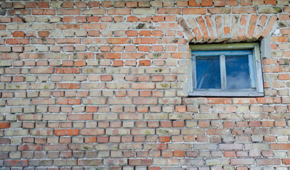 Fototapeta na wymiar Red brick old wall with old window