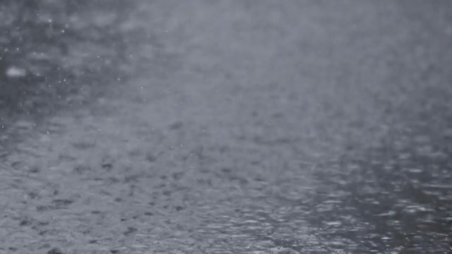 Image of rain falling on concrete ground