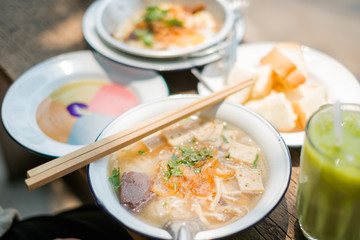 Thai food set consist of Steamed bread with colourful thai custard,Iced matcha tea,Vietnamese Pork Rice Noodle Soup and  Fried eggs pan