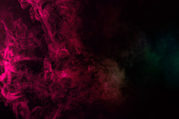 Colored background with winding clouds of smoke from patterns of different forms of pink, green and blue colors with tongues of flame on a black isolated background