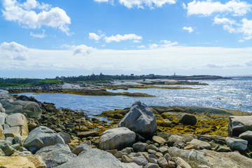 Fototapeta na wymiar Rocky shore with Peggys Cove in the background