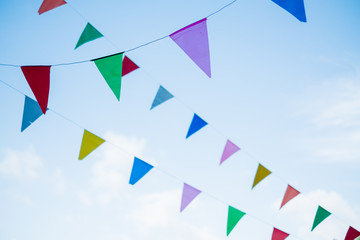festival flag line with blue sky in background