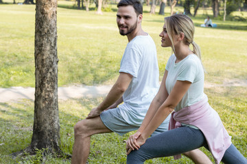 Couples are exercising in the park.