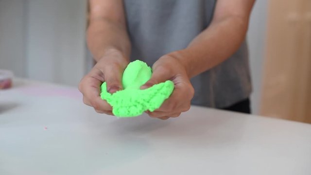 child play with kinetic sand. playing with kinetic sand.