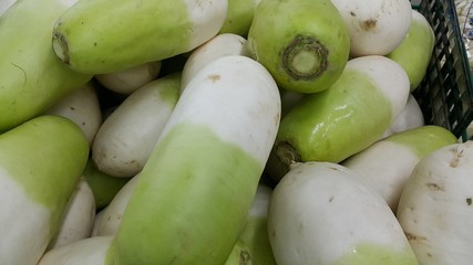 Vegetable background: Large radish pile in supermarket.