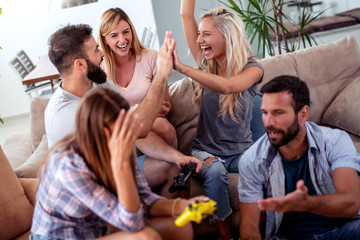 Friends play video games at home