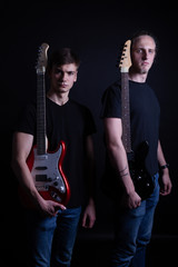 Obraz premium Rock band consisting of two young caucasian adults posing in the studio