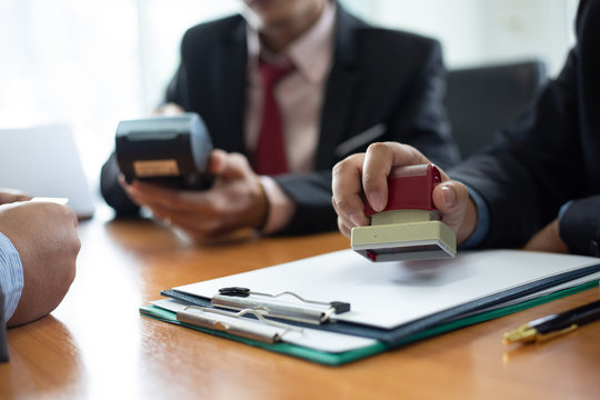 Close Up Of Hands Businessman Being Stamped With The Company Contract Of Construction Bidding .concept Of Payment