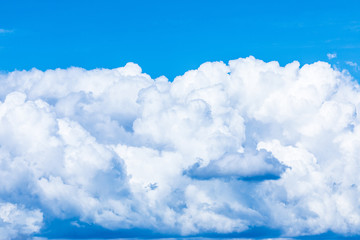 The vivid sky or heaven background with white and blue clouds under the sun rays