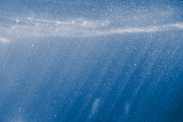 sunny blue underwater background with particles