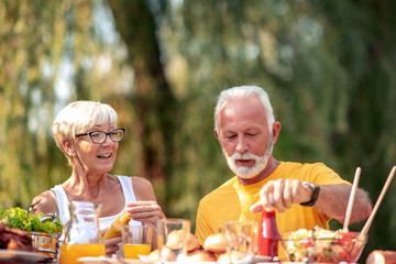 Senior couple have a meal in nature