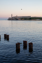 Fototapeta premium Beautiful view of the Lighthouse in the Old Havana City, Capital of Cuba, during a colorful and sunny sunrise.