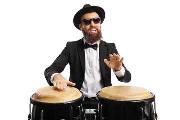 Portrait of a man in a suit playing conga drums