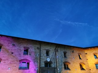 Pink and yellow lighted building with blue sky