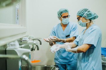 Unrecognizable doctor washing hands before operating