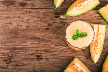 The juice of melon with mint in a glass jar on the table.Hami melon