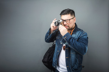 A mature man carries his schoolbag and equipment to travel.