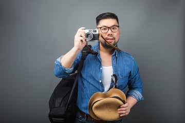 A mature man carries his schoolbag and equipment to travel.