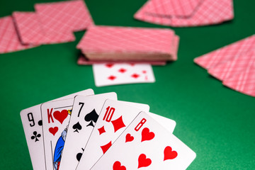 playing cards on a green table in different combinations close-up
