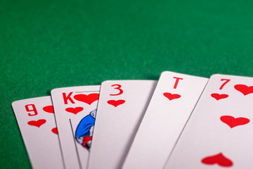 playing cards on the green table. Combination "flush" in poker