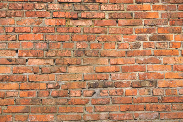 Old brick wall weathered and broken bricks, background