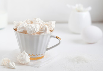 Meringues. Protein sugar cake for tea or coffee. Light background.White morning. Candy