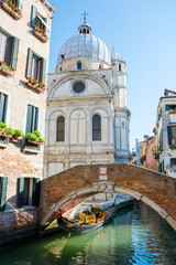 Fototapeta na wymiar View of the canal, bridge and church of Santa Maria dei Miracoli, Venice, Italy