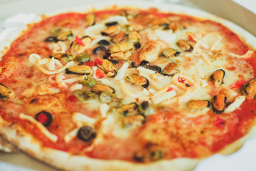 Pizza with seafood mussels olives top view