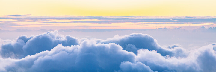 Sky panoramic banner background of clouds at sunset.