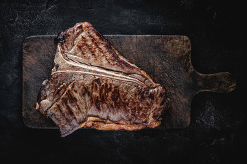 Barbecue Grilled Dry Aged Beef T-bone Steak on Rustic Cutting Board - 276764602