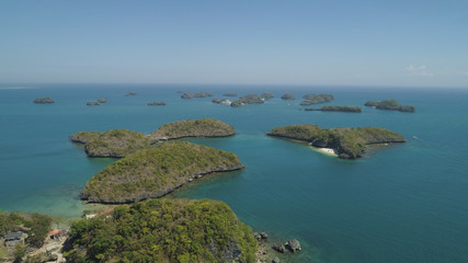 Fototapeta na wymiar Aerial view of Small islands with beaches and lagoons in Hundred Islands National Park, Pangasinan, Philippines. Famous tourist attraction, Alaminos.