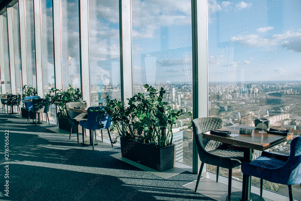 Wall mural booked a table in the restaurant moscow city on 89 floors. served with two glasses and cutlery.