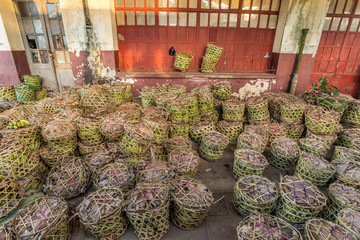 Wicker baskets with fruit and goods as cargo on an old train platform. Manakara Madagascar.